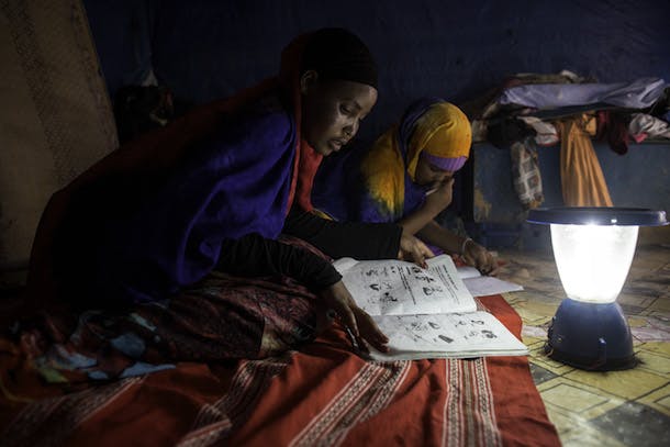 Students work on their homework with the help of a solar lantern at Awbare Refugee Camp in Somali region of Ethiopia 13 March 2014. Photo by Jiro Ose