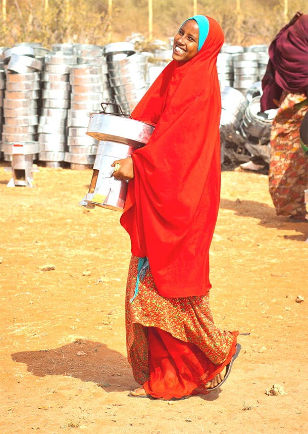 Woman carrying stove