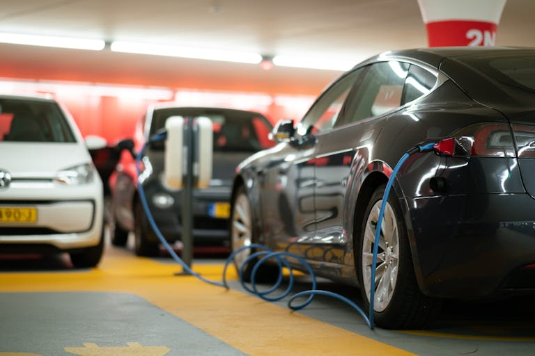 Electric cars charge up in a garage