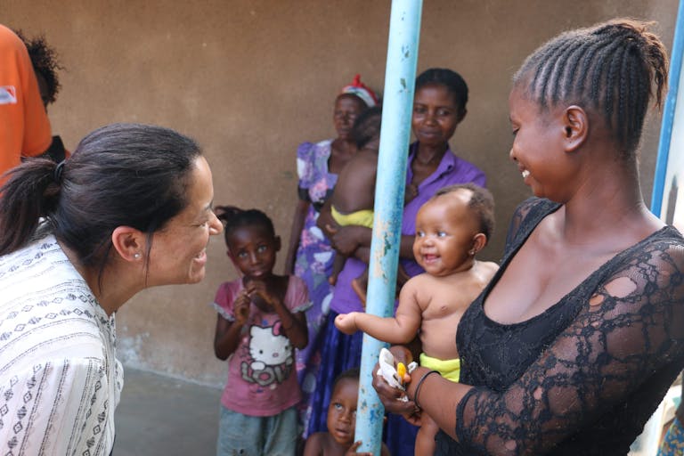 Valerie Guarnieri greets an infant in the Democratic Republic of the Congo